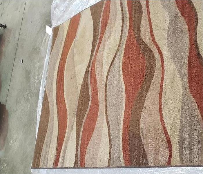 dirty red and beige rug at SERVPRO of Southeast Memphis warehouse 